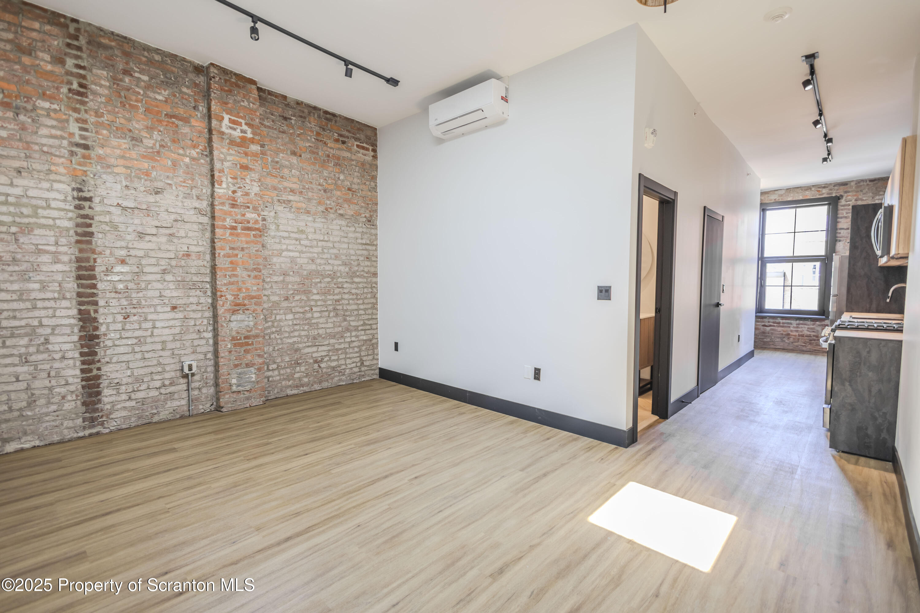117 Penn Avenue Scranton, PA 18503 - Photo 17 of 25 a view of empty room with wooden floor and fan