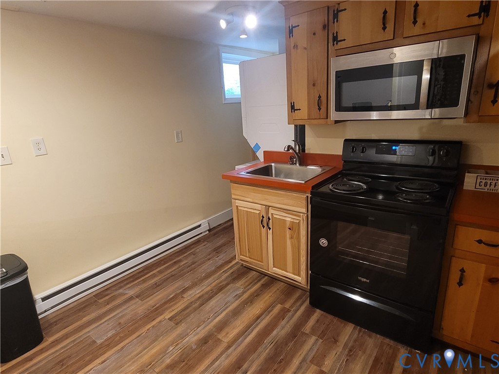 232 High Street, Unit B Petersburg, VA 23803 - Photo 4 of 7 a kitchen with a stove and a microwave
