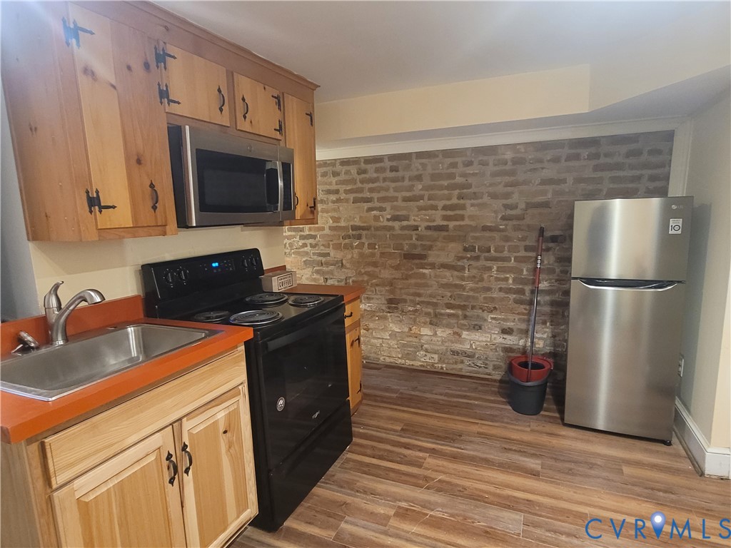 232 High Street, Unit B Petersburg, VA 23803 - Photo 5 of 7 a kitchen with stainless steel appliances a stove microwave and refrigerator