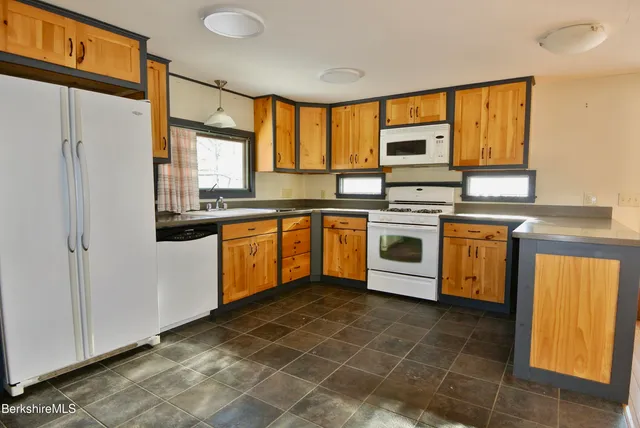 a kitchen with stainless steel appliances granite countertop a stove sink and refrigerator