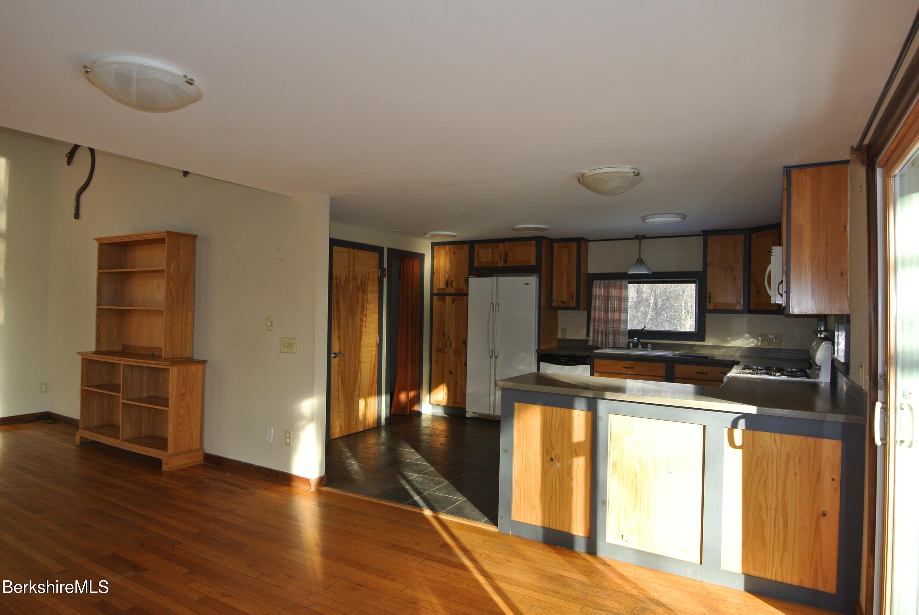9 Cone Hill Road West Stockbridge, MA 01266 - Photo 13 of 20 a kitchen with stainless steel appliances granite countertop a refrigerator a stove and a wooden floors