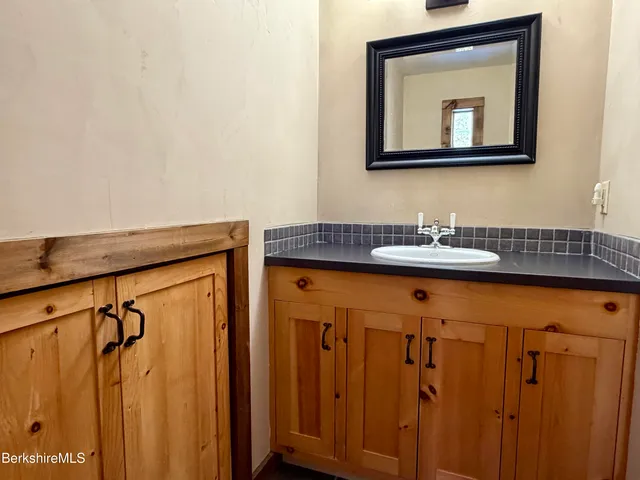 a bathroom with a sink a mirror and a shower curtain