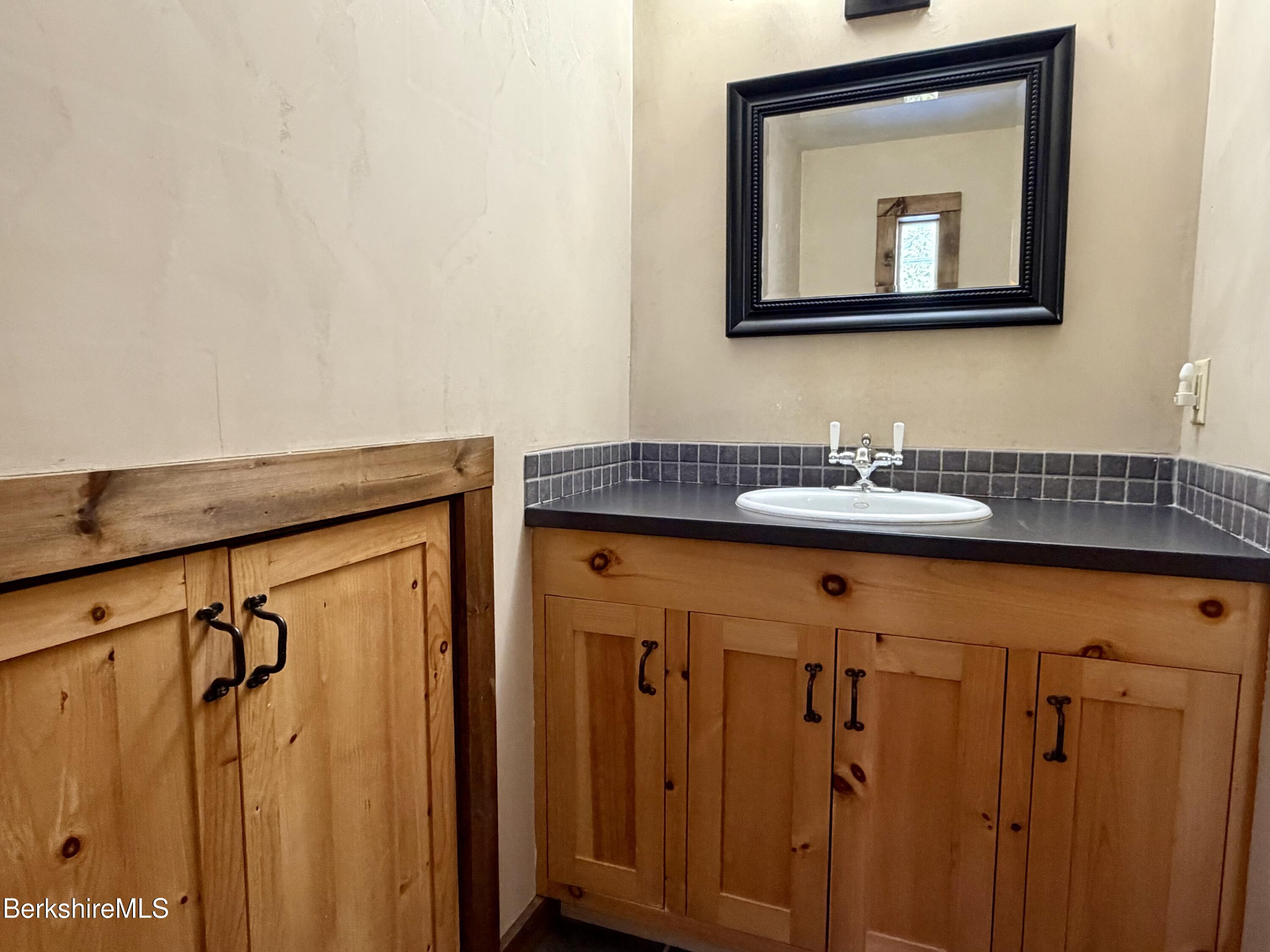 9 Cone Hill Road West Stockbridge, MA 01266 - Photo 20 of 20 a bathroom with a sink a mirror and a shower curtain
