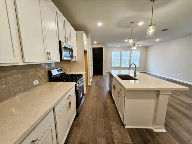 a view of a kitchen with a sink and a microwave