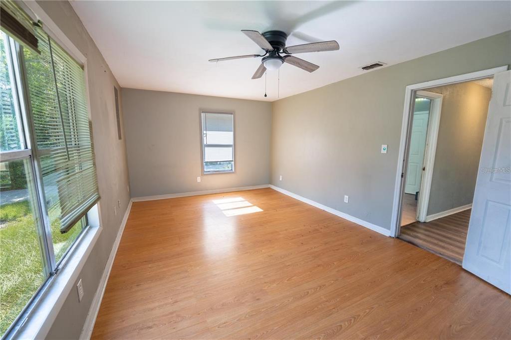 535 West Division Street Deland, FL 32720 - Photo 15 of 25 wooden floor in an empty room with a window