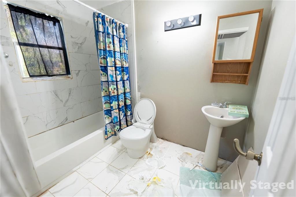 535 West Division Street Deland, FL 32720 - Photo 16 of 25 a bathroom with a sink toilet and shower