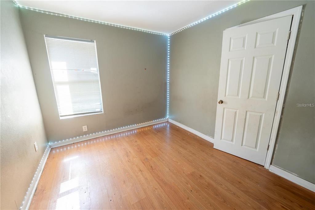 535 West Division Street Deland, FL 32720 - Photo 19 of 25 an empty room with wooden floor and windows