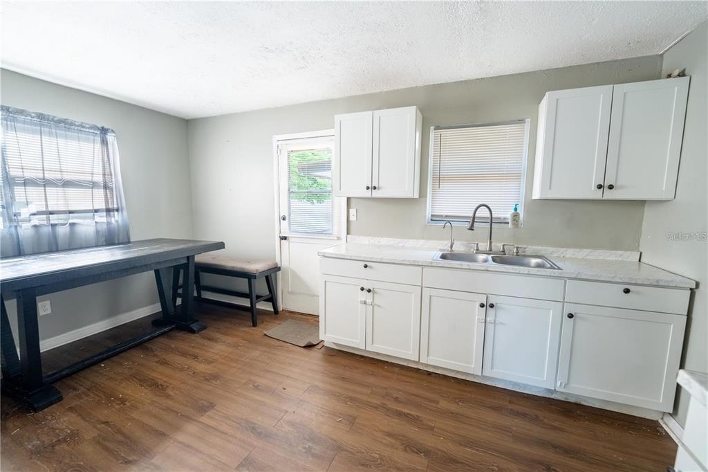 535 West Division Street Deland, FL 32720 - Photo 6 of 25 a kitchen with sink cabinets and wooden floor