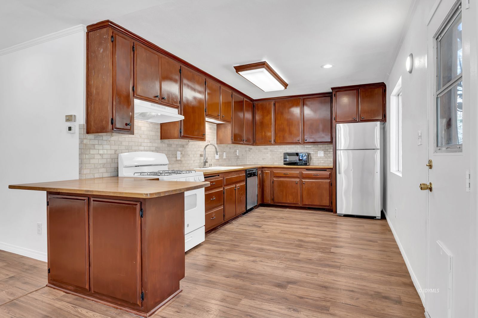 25459 Palomar Road Idyllwild, CA 92549 - Photo 24 of 51 a kitchen with a sink refrigerator and cabinets