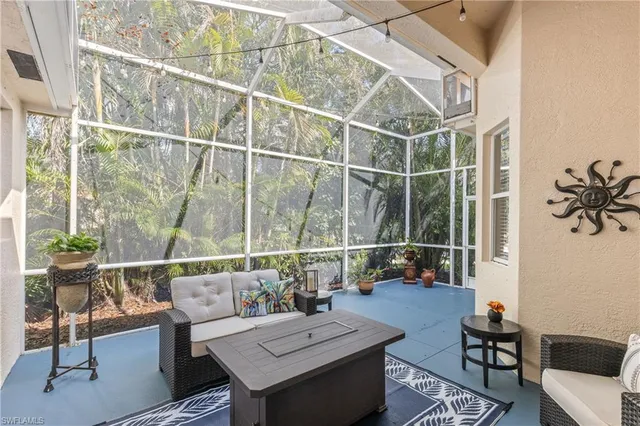 a living room with furniture a rug and a potted plant