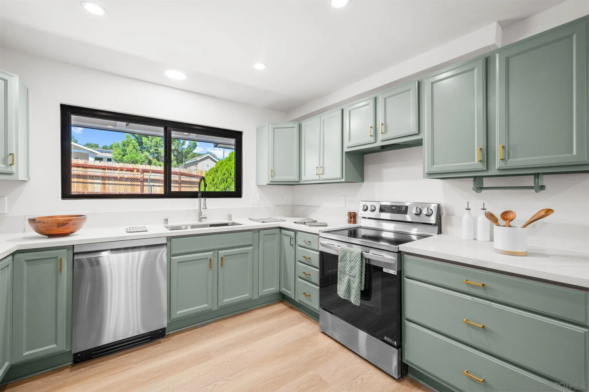 15277 Oak Creek Road El Cajon, CA 92021 - Photo 16 of 71 a kitchen with stainless steel appliances granite countertop wooden cabinets a sink and a stove