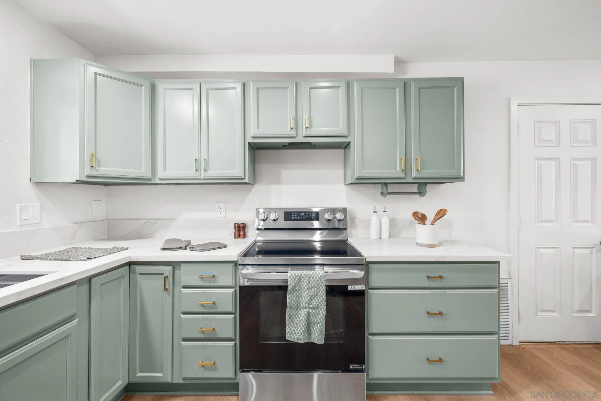 15277 Oak Creek Road El Cajon, CA 92021 - Photo 17 of 71 a kitchen with stainless steel appliances granite countertop a stove and a white cabinets