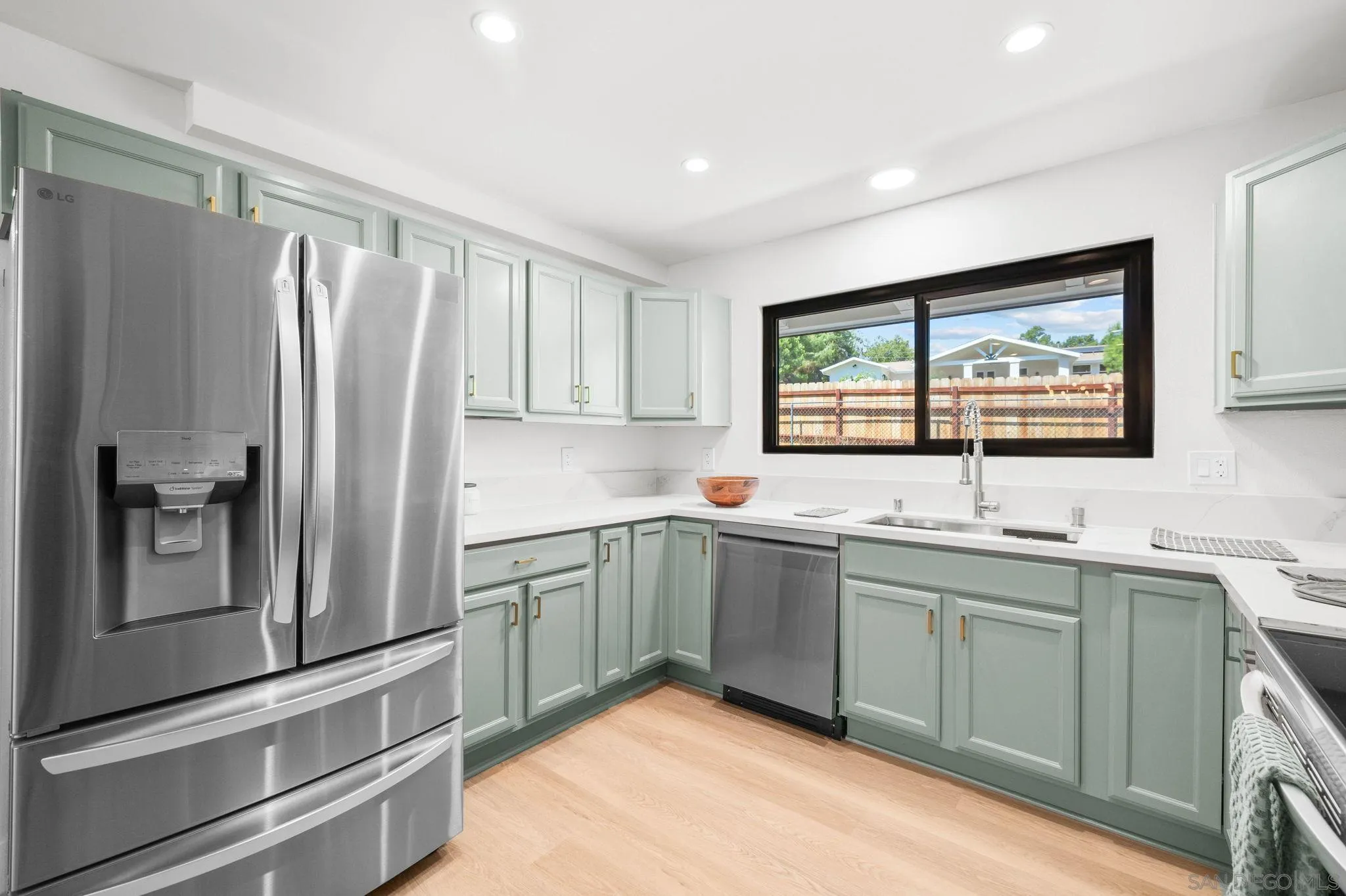 15277 Oak Creek Road El Cajon, CA 92021 - Photo 18 of 71 a kitchen with stainless steel appliances granite countertop a refrigerator and a sink