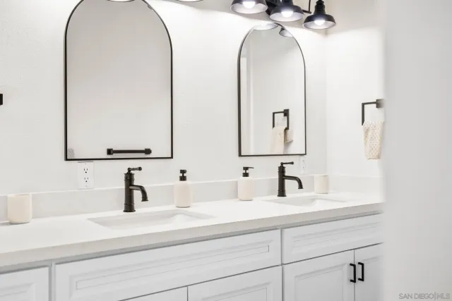 an empty room with ceiling fan and window