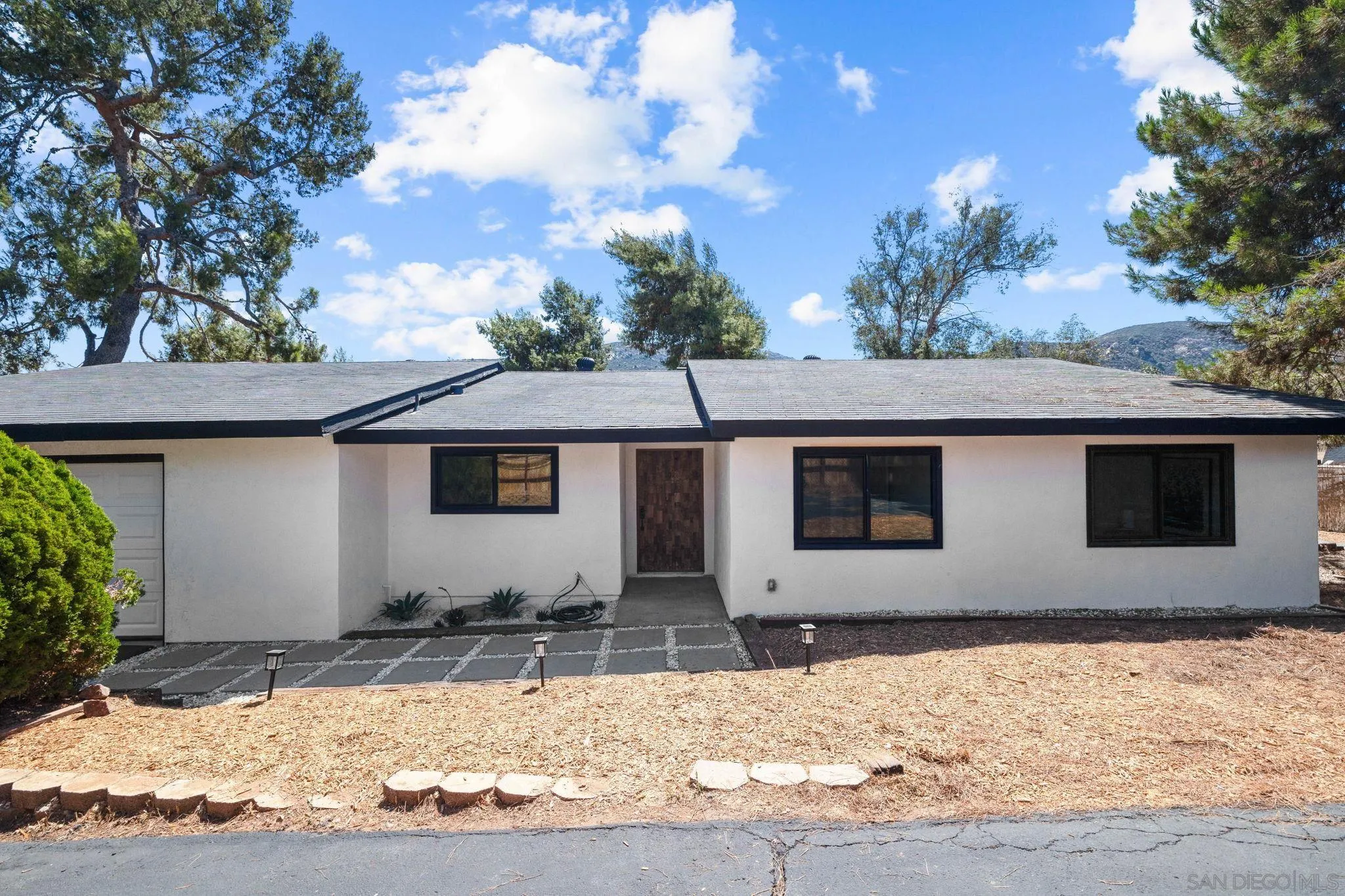 15277 Oak Creek Road El Cajon, CA 92021 - Photo 3 of 71 a front view of house with yard covered in snow