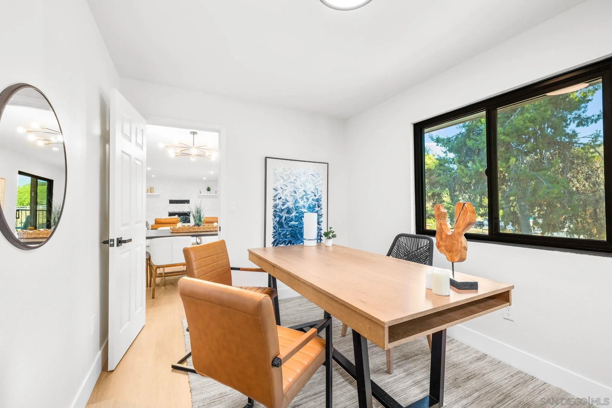 15277 Oak Creek Road El Cajon, CA 92021 - Photo 34 of 71 a living room with a table chairs and a view of kitchen