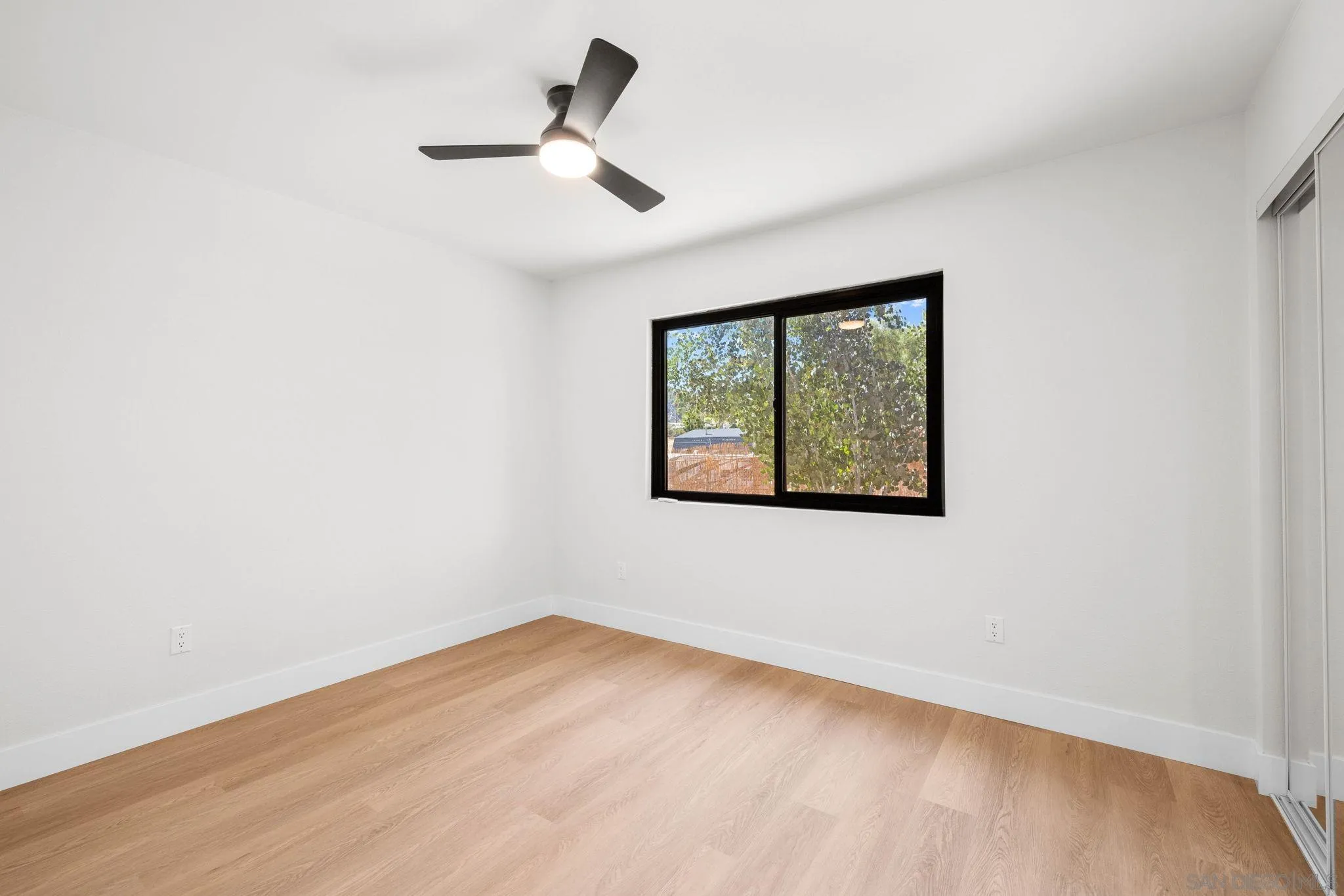 15277 Oak Creek Road El Cajon, CA 92021 - Photo 43 of 71 an empty room with a window and ceiling fan