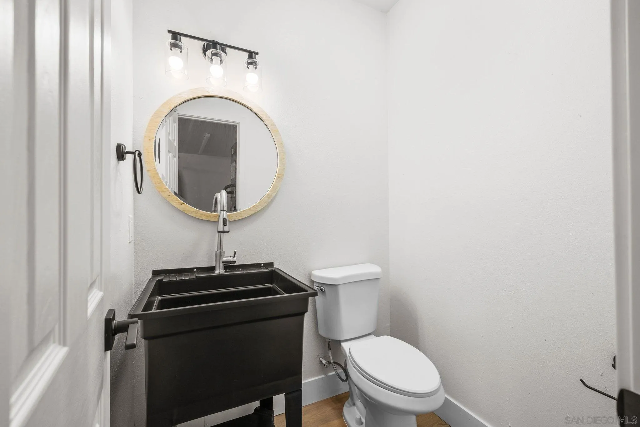 15277 Oak Creek Road El Cajon, CA 92021 - Photo 49 of 71 a bathroom with a toilet a sink and a mirror