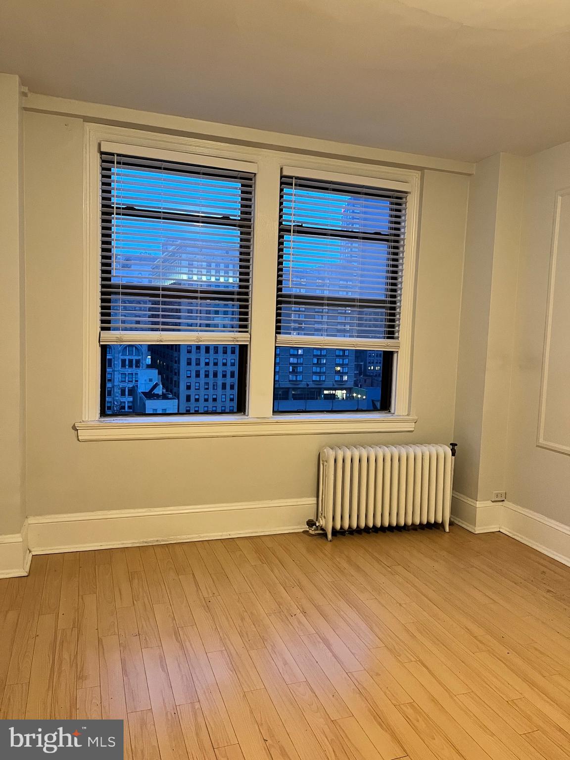 1324-32 Locust Street, Unit 1108 Philadelphia, PA 19107 - Photo 8 of 11 a room with a wooden floor and a window