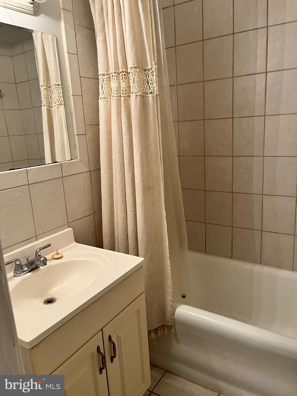 1324-32 Locust Street, Unit 1108 Philadelphia, PA 19107 - Photo 9 of 11 a bathroom with a sink and a bathtub