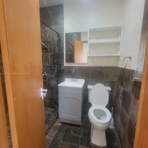 a bathroom with a toilet a sink and a mirror