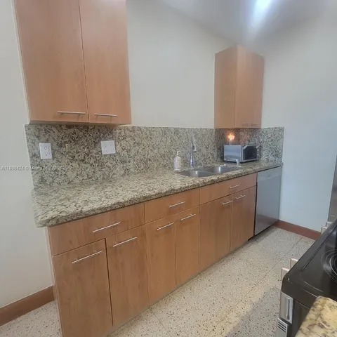 a kitchen with stainless steel appliances granite countertop a sink and cabinets