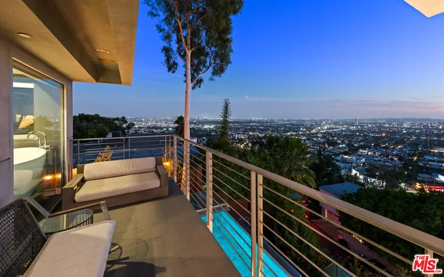 a bed room with a bed and a chair