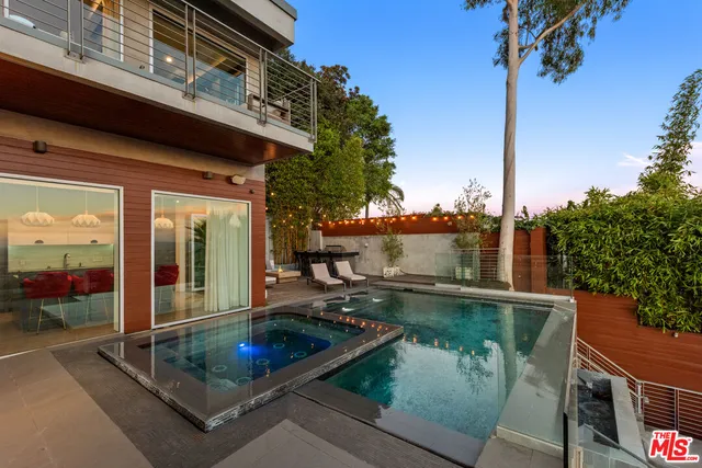a patio with a table and chairs under an umbrella
