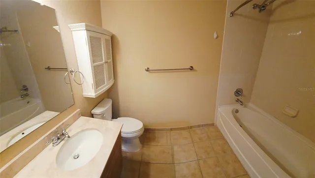 a bathroom with a tub a sink and a shower