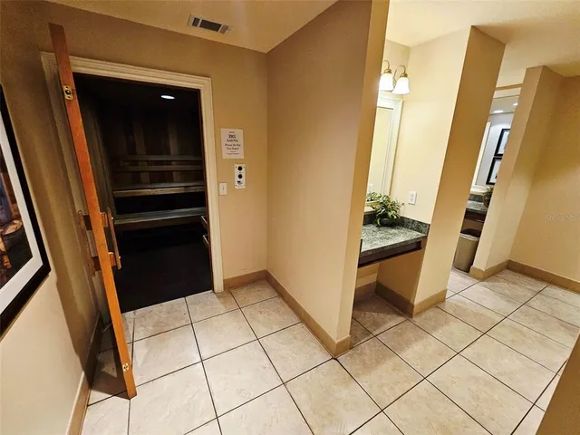 a living room with patio furniture and a flat screen tv