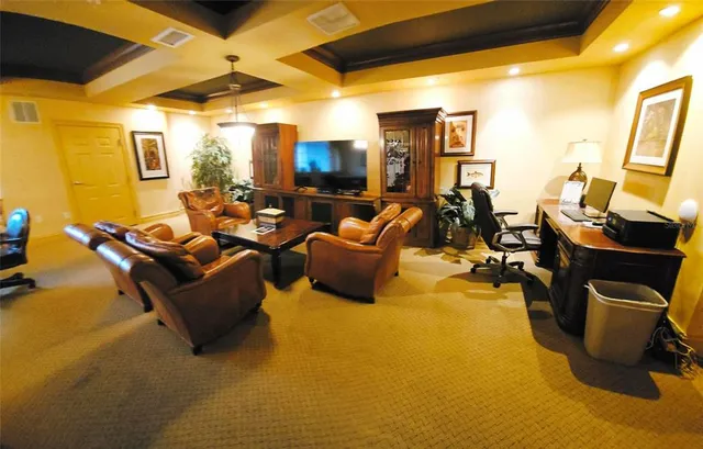 a view of a workspace with furniture and wooden floor