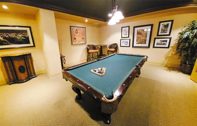 a living room with furniture kitchen view and a large window