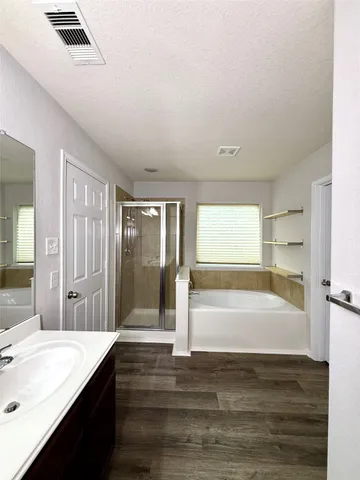 a bathroom with a bathtub and a sink