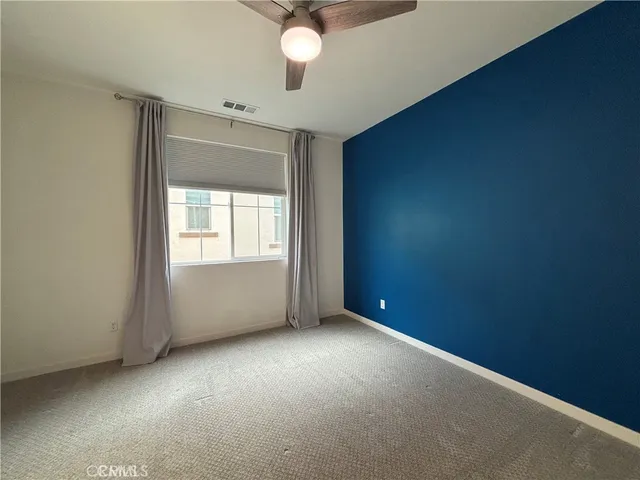 an empty room with a empty space and windows