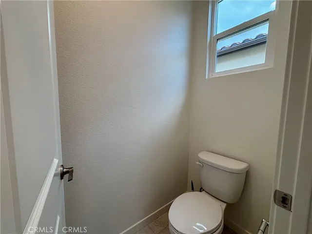 a white toilet sitting next to a shower