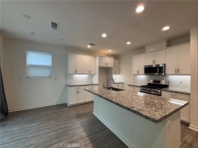 a kitchen with a stove a sink and a refrigerator