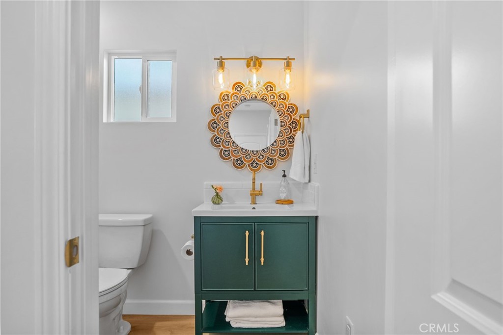 426 Jacaranda Place, Unit A Fullerton, CA 92832 - Photo 13 of 41 a bathroom with a toilet sink vanity and mirror