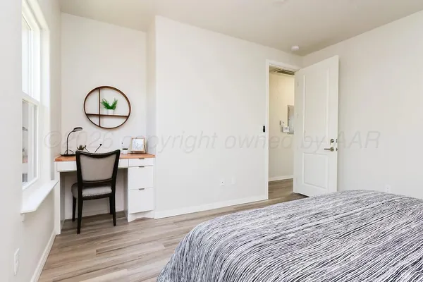 a bedroom with a bed and a table