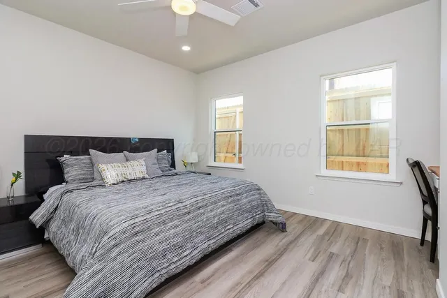 a bedroom with a bed and wooden floor