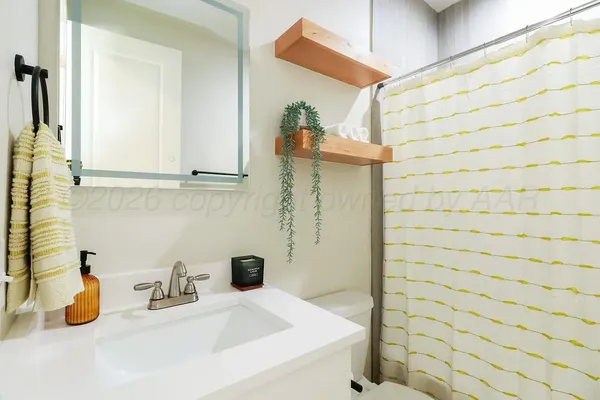 a bathroom with a sink and a shower