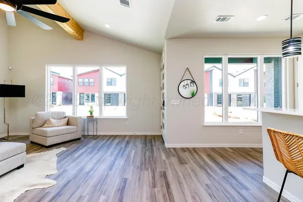 a living room with furniture and a large window