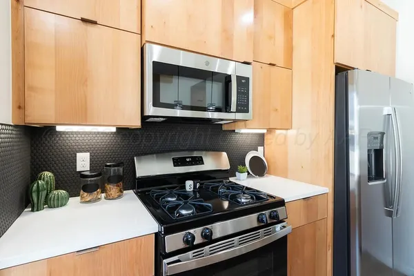 a kitchen with a stove and a microwave