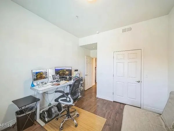 a bedroom with a bed and wooden floor