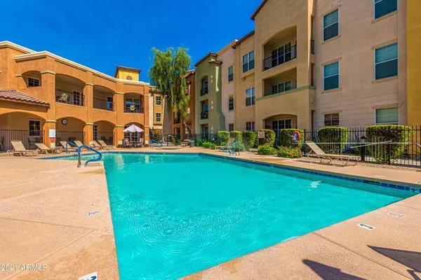 a view of a balcony with chairs and a potted plant