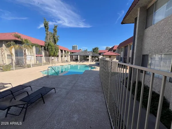 a view of a house with backyard and sitting area