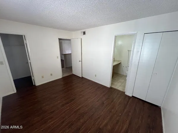 a view of a room with wooden floor and a sink