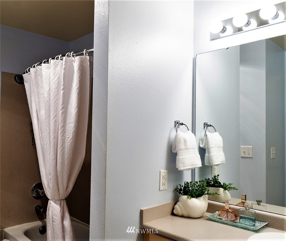 3918 243rd Place Southeast, Unit F304 Bothell, WA 98021 - Photo 11 of 25 a room with a window and a potted plant