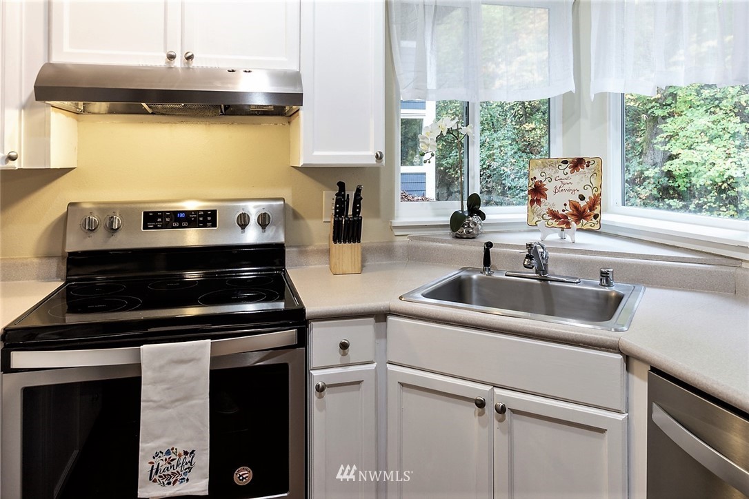 3918 243rd Place Southeast, Unit F304 Bothell, WA 98021 - Photo 14 of 25 a kitchen with a stove and a sink