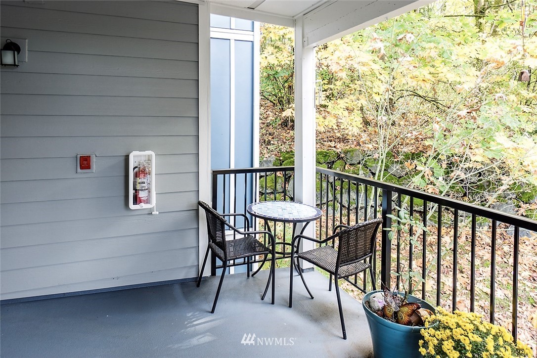 3918 243rd Place Southeast, Unit F304 Bothell, WA 98021 - Photo 18 of 25 a view of a chairs and table in the balcony