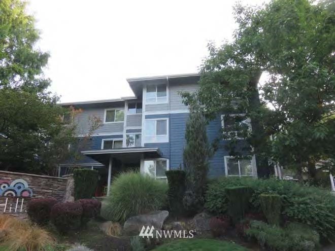 3918 243rd Place Southeast, Unit F304 Bothell, WA 98021 - Photo 20 of 25 a view of a house with a yard and potted plants
